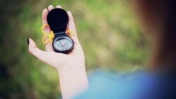 Hiker woman holding a compass on nature Stock Footage