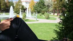 DOLLY: Young Man Reading Book Stock Footage