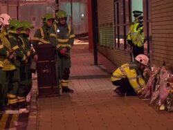 Paramedics laying wreath at helicopter crash scene News Clip