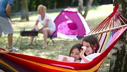 Beautiful Sisters Relaxing Together In The Hammock Stock Footage