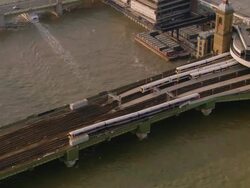 Aerial medium shot pan train leaving Cannon Street Station across bridge / London, England Stock Footage