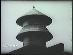 1942: WAR HOME FRONT: VS Men fitting cap on top of roof vent (unconfirmed), sandbags being piled on streets & against building entrance. WWII, World War II, war defense, preparation Instructional Video