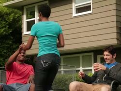 MS TU TD Two men relaxing in chairs on backyard lawn and woman giving beverages / Portland, Oregon, United States Stock Footage