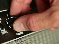 HD Guitarist Turning Amplifier Volume Knob (4:2:2) Stock Footage