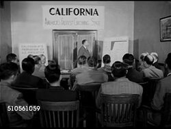 1945: CALIFORNIA: DOWNTOWN: Center of street WS Bus moving down, cars moving up street. MS 'Sacramento Chamber of Commerce' sign. VS Businessmen in meeting. MS Chart showing California as fastest growing state in nation as of July 1, 1945. Post WWII. Instructional Video