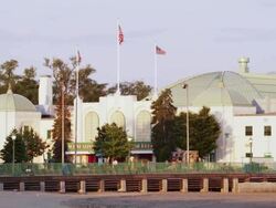 Boardwalk on the beach of Rye Playland in New York with railing and restaurante in Deco style ,at sunset Stock Footage