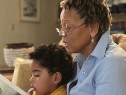 Grandmother and grandson putting together puzzle Stock Footage