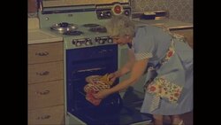MS Senior woman taking cherry pie from the oven / United States Stock Footage