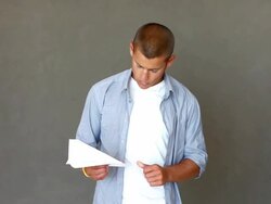 Young man throwing a paper airplane Stock Footage