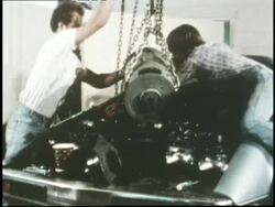 Factory workers work on an electric car. News Clip