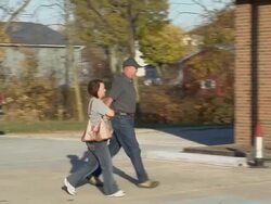 MS, PAN, People walking through parking lot and entering through door with american flag on it, New Knoxville, Ohio, USA Stock Footage