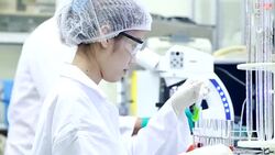 Scientist using microscope and looking a sample Stock Footage