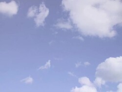 Girl in deckchair, zoom in to sky backdrop Stock Footage
