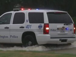 CU TS ZO Shot of heavy rain with police car on flooded road during Tropical Storm Hermine / Arlington, Texas, United States Stock Footage