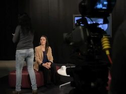 Female presenter receiving make up in studio Stock Footage