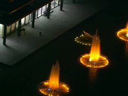 Aerial CU fountains at night, with orange and yellow lights in water, Century City / Beverly Hills, California, United States. Stock Footage