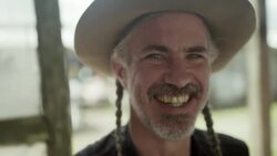 Friendly Texan shop owner smiles and laughs into camera Stock Footage