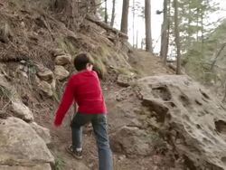 WS POV Boy hiking up mountain trail with stick / Oak Creek, Arizona, USA Stock Footage