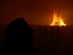 Lady watching fireworks with Bonfire in background, UK. 2006; short sequence. Stock Footage
