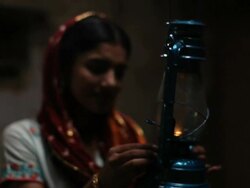 Woman burning lantern at night, Faridabad, Haryana, India  Stock Footage