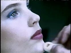 zoom in extreme close up of makeup artist's hands using sponge to put makeup on model's face Stock Footage