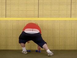 Medium shot fat man lifting weights w/sweatpants hanging low Stock Footage