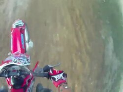 POV helmet cam view of motocross motorcycle riding and doing a jumping trick. - 1920x1080 Stock Footage