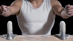 SLO MO Male gymnast holding the handles on pommel horse Stock Footage