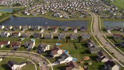 Houses, swimming pools and lakes dot a suburban neighborhood near Chicago, Illinois. Stock Footage