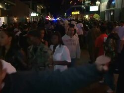 Medium Shot High Angle - Crowds on Bourbon Street smiling and making faces at the camera / New Orleans Louisiana Stock Footage