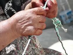HD: Villager woman is knitting socks Stock Footage