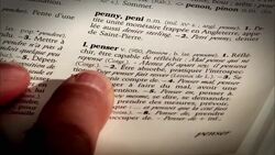A finger points at the definition of a word in french dictionary. Stock Footage