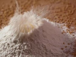 Egg yolk falling in the flour  Stock Footage