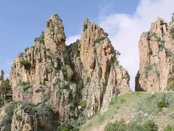 MS Cars on the road through the fantastic rock landscape of the Calanche of Piana, UNESCO World Heritage Site / Gulf of Porto, Corsica, France Stock Footage
