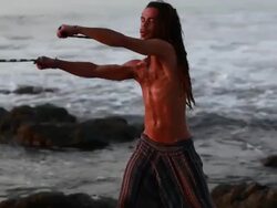 MS TS Rasta man spinninig poi balls with ocean / Montezuma, Punteranes, Costa Rica Stock Footage