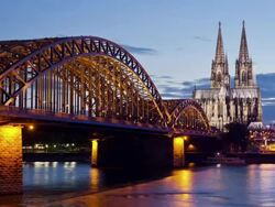 WS T/L View of Hohenzollern Bridge with Cologne Cathedral and Rhine river at dusk / Cologne, North Rhine Westphalia, Germany    Stock Footage