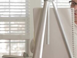 Mixed race man sketching at easel Stock Footage