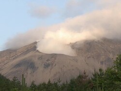 Wide shot of steam pouring from Sakurajima volcano, Japan at dawn Stock Footage