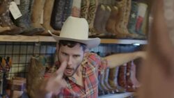 Young man in cowboy hat goofs off in Western store until his friend walks in and embarrasses him Stock Footage