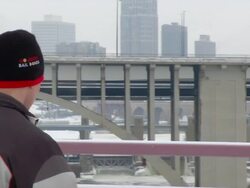 MS PAN Man throwing snowball off of bridge / Minneapolis, Minnesota, United States Stock Footage