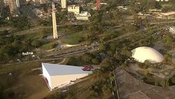 A dome, obelisk, and a wedge-shaped building occupy a forested area. Stock Footage