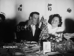 1950: BEAULIEU: DORDOGNE VALLEY:  VS People celebrating at wedding banquet in pavilion, newly wed couple sitting together before cake, guests standing up for toast. EXT WS Wedding party gathered for photograph. Instructional Video