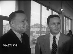 1952: POSTMASTER GENERAL: MS Title, Angled WS Summerfield Chevrolet dealership, WS Arthur E. Summerfield (1899-1972) greeting customer in showroom, MS Sitting at desk SOT, saying objective is improve postal service, explore twice day delivery. Instructional Video