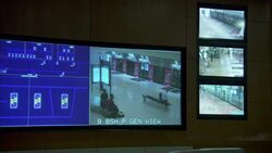 A video screen shows multiple views from security cameras. Stock Footage