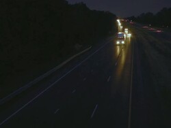 MS TS Shot of truck amid auto traffic on interstate highway at night / Chelsea, Michigan, United States Stock Footage
