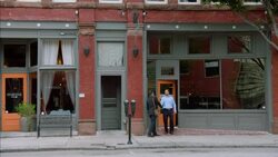 Financial advisor shakes hands with restaurant owner on street outside of business Stock Footage
