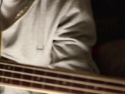 A young man plays his bass guitar. - Model Released - 1920x1080 - HD Stock Footage