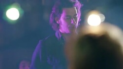 Medium dolly shot of lead guitar through party crowd Stock Footage