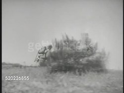 1945: OKINAWA, JAPAN: US Marines running on top of hill, bombs exploding. *(OTS) Soldier firing rifle into smoking valley. (OTS) Soldier firing machine gun. Pacific Theater, WWII, World War II. Instructional Video