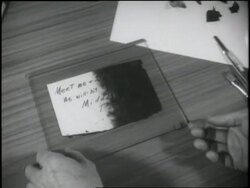 A Federal Bureau of Investigation agent demonstrates the restoration of a charred document for trainees. News Clip